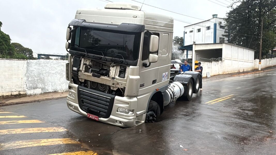 Caminhão fica preso em cratera após asfalto ceder em avenida de Rio das Pedras